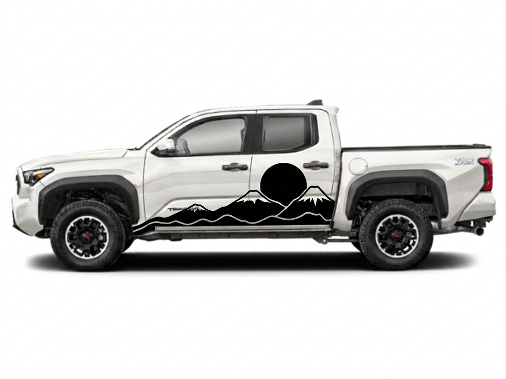 A white Toyota Tacoma pickup truck shown in side profile on a light gray background, featuring a black mountain and sun graphic decal along the lower side panel.
